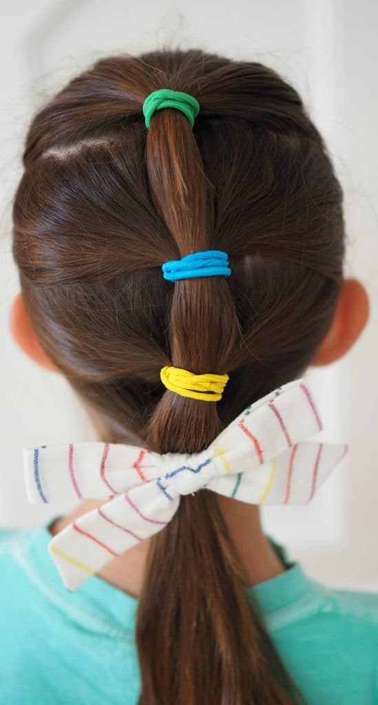 Playful Ponytails With Colorful Bow Playful Ponytails With Colorful Bow — Winter Hairstyles for Kids