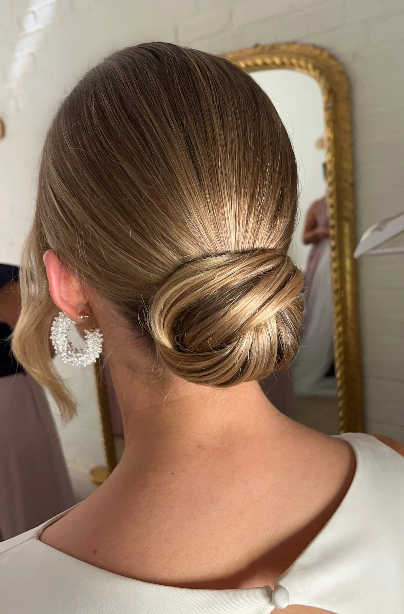 Sleek Light Brown Low Bun — Winter Wedding Guest Hairstyles
