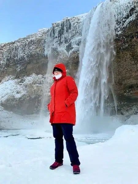 Bright Red Hooded Parka with Navy Trousers in Snowy Landscape Bright Red Hooded Parka with Navy Trousers in Snowy Landscape — Iceland Winter Outfits