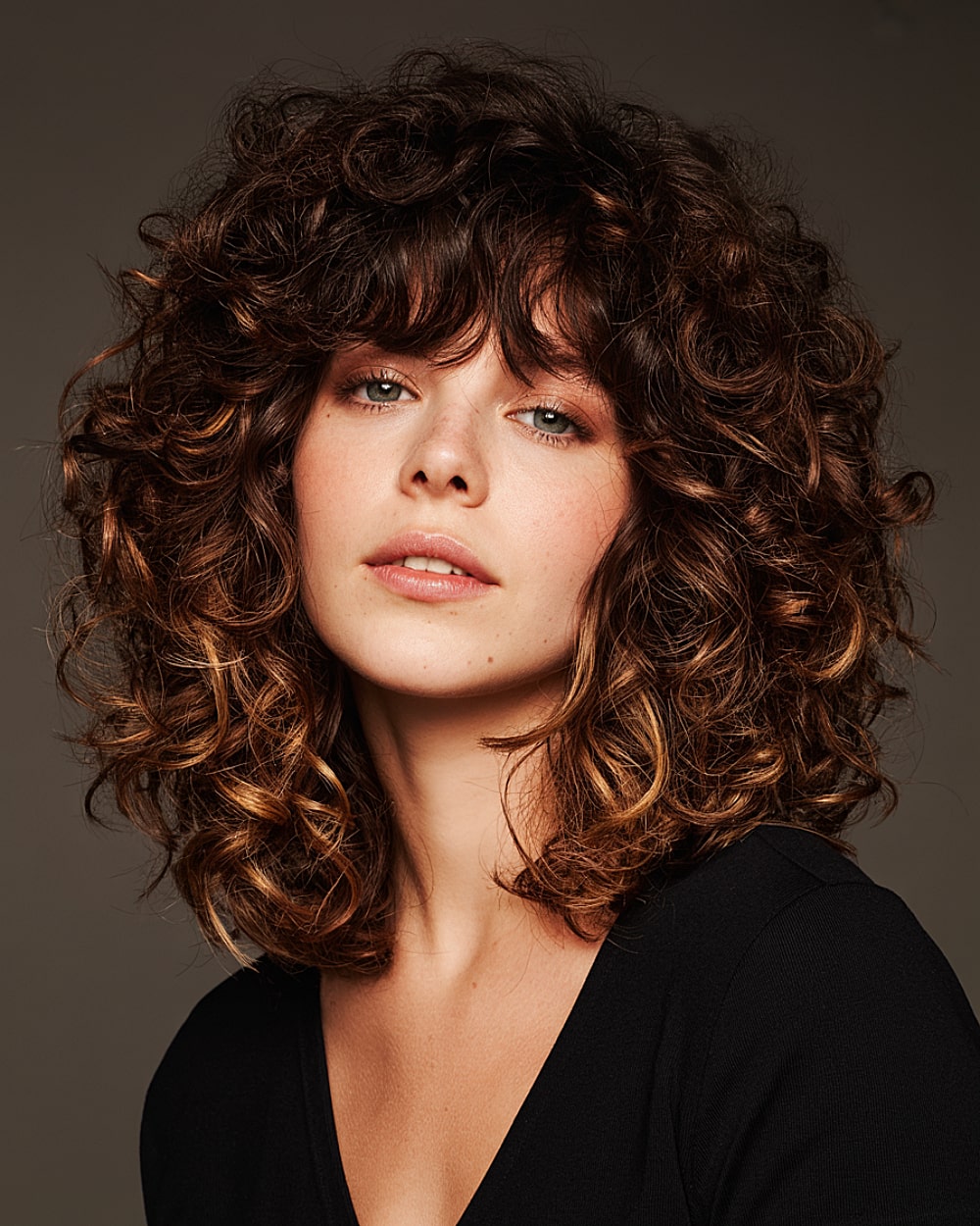 Curly Bangs Shoulder-Length Dark Brown Curly Shag With Auburn Highlights Curly Bangs Shoulder-Length Dark Brown Curly Shag With Auburn Highlights — Winter Shag Haircuts