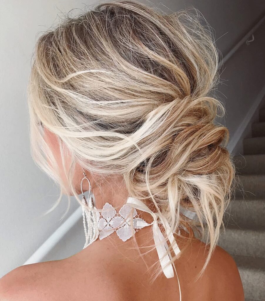 Ash Blonde Messy Bun With Tendrils — Winter Wedding Guest Hairstyles