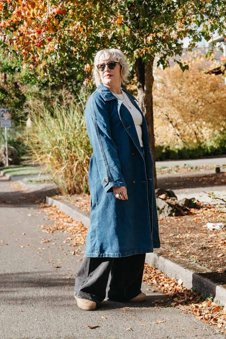 Medium Wash Denim Trench Coat with Black Corduroy Trousers — Long Coat Outfits