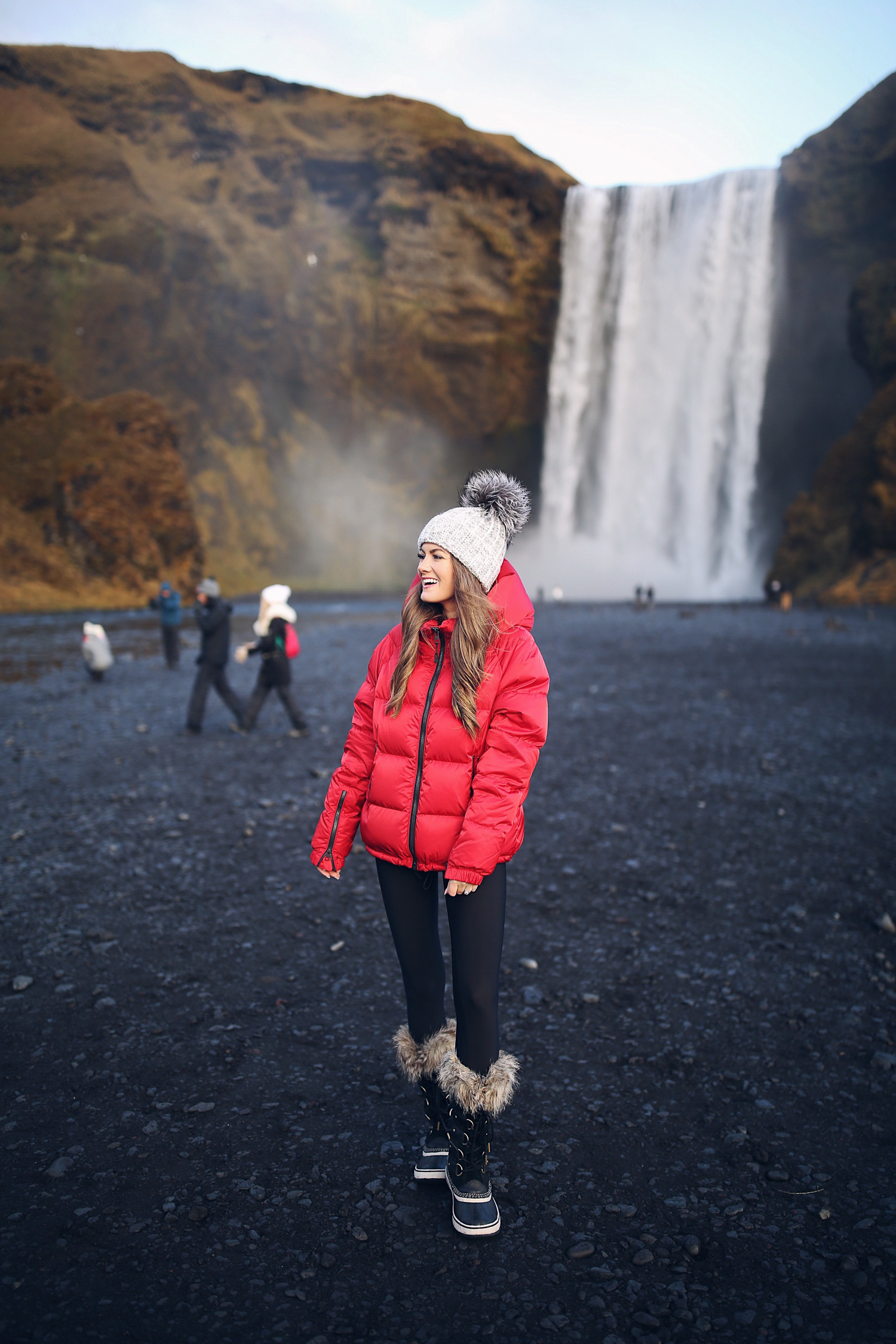 Vibrant Red Puffer Jacket with Fur-Trimmed Boots for Sightseeing Vibrant Red Puffer Jacket with Fur-Trimmed Boots for Sightseeing — Iceland Winter Outfits