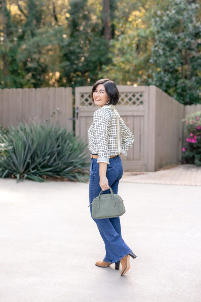 Tan Suede Heeled Ankle Boots with Flared Jeans and Patterned Blouse — Suede Boots Outfits
