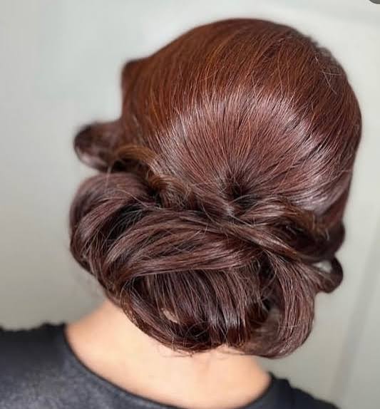Polished Low Bun with Braided Detail — Winter Hairstyles for Plus Size Women