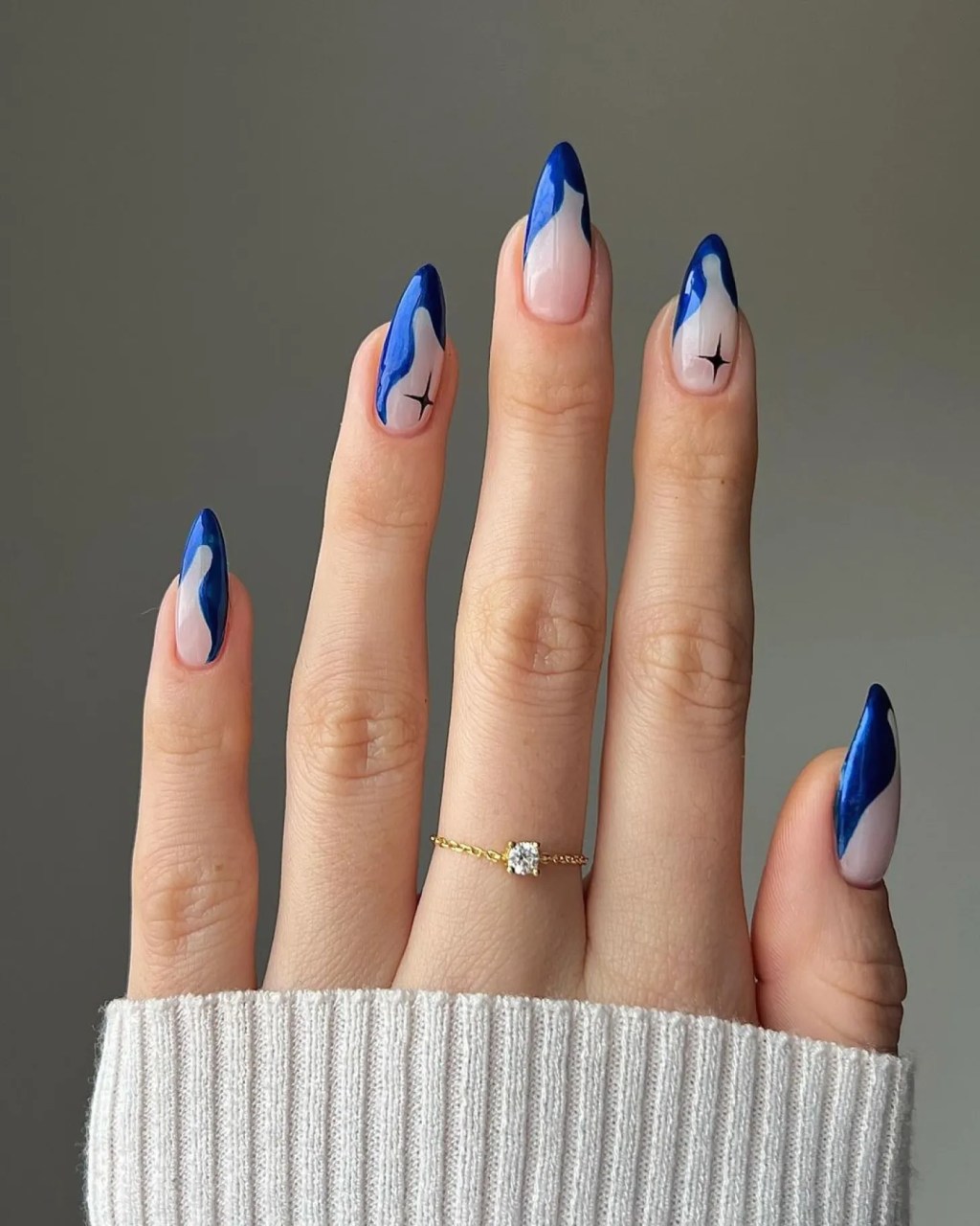 Royal Blue Swirls on Nude Almond Nails — Winter Acrylic Nail Colors
