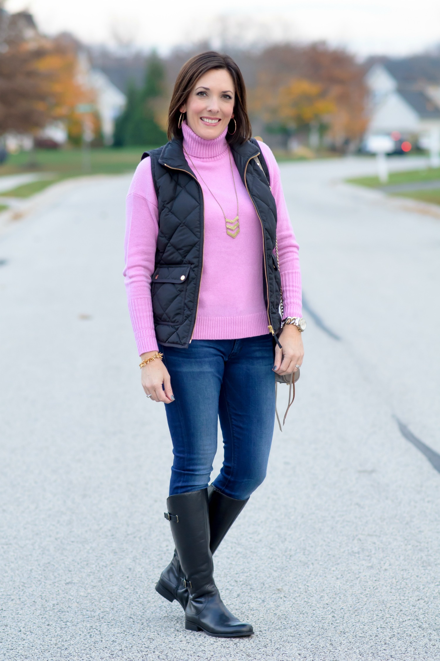Casual Winter Black Puffer Vest with Pink Turtleneck and Blue Jeans Casual Winter Black Puffer Vest with Pink Turtleneck and Blue Jeans — Puffer Vest Outfits