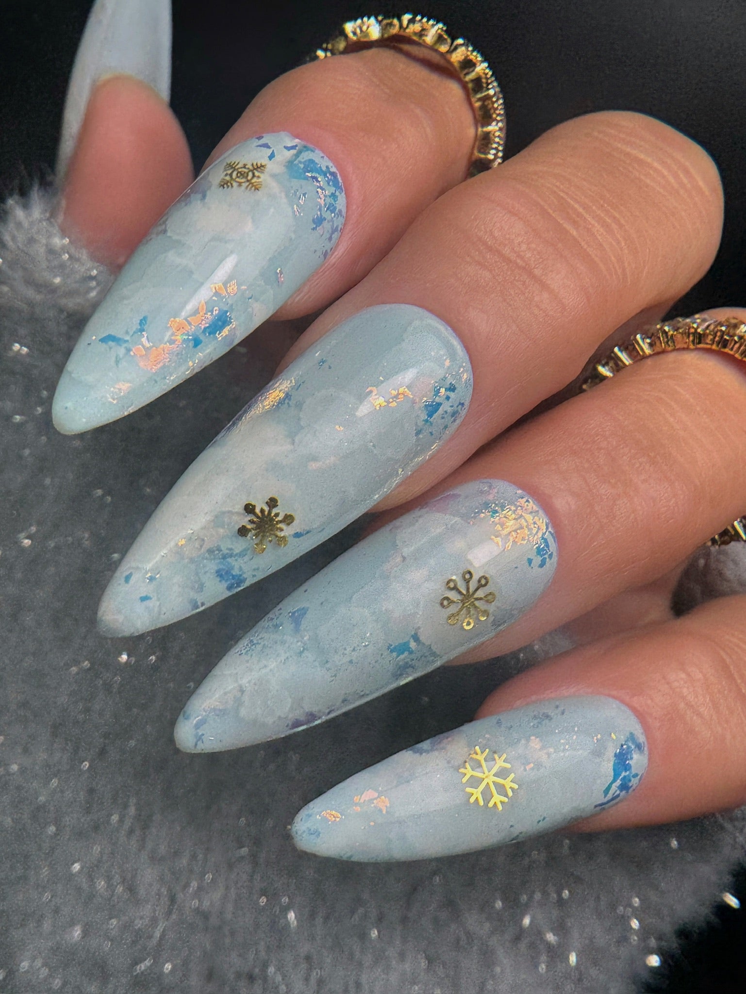 Pale Blue Marbled Stiletto with Snowflake Charms Pale Blue Marbled Stiletto with Snowflake Charms — Winter Vacation Nails