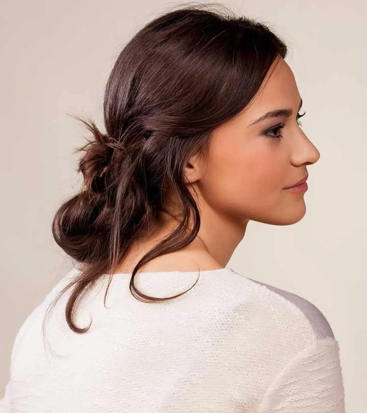 Medium Length Dark Brown Messy Bun With Loose Tendrils — Easy Winter Hairstyles