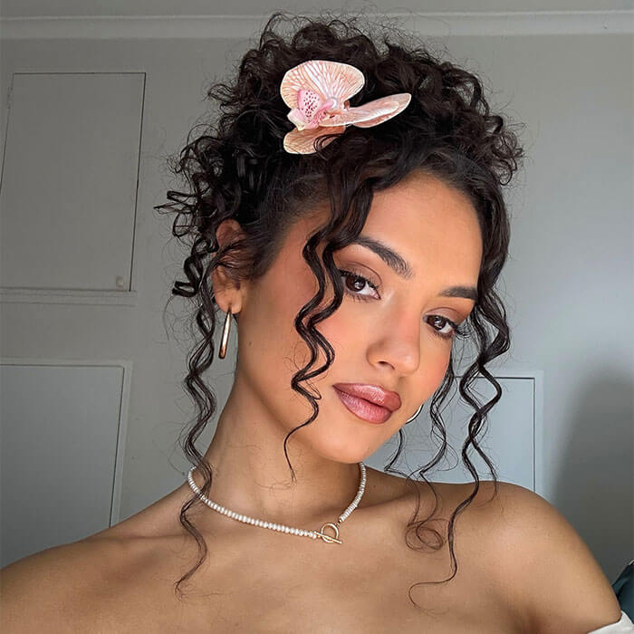 Dark Brown Updo With Orchid Dark Brown Updo With Orchid — Winter Hairstyles for Curly Hair
