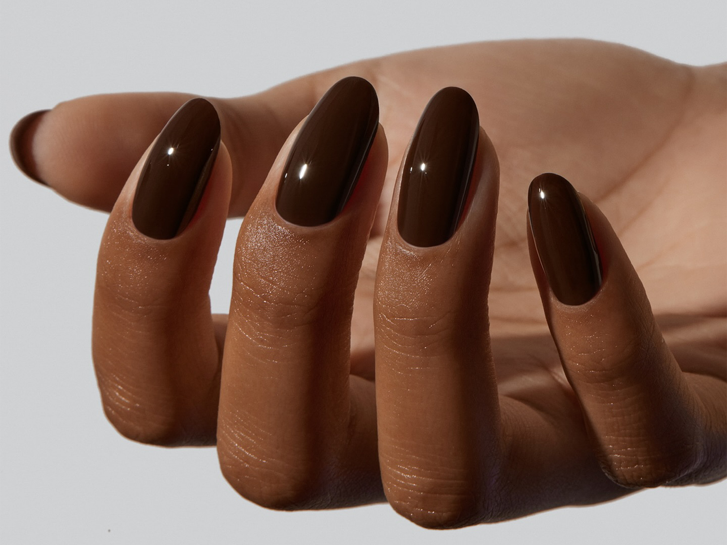 Deep Glossy Brown Medium Oval Nails — The Cuticle Area Is Clean Deep Glossy Brown Medium Oval Nails — The Cuticle Area Is Clean — Winter Nail Colors for Dark Skin