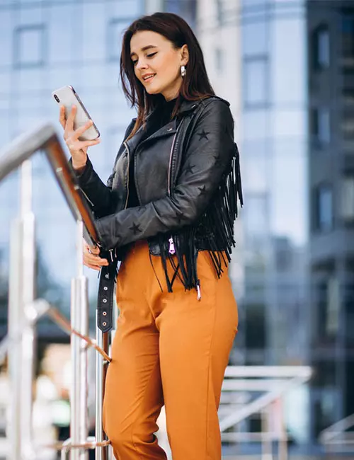 Bold Statement: Embellished Leather Jacket with Orange Pants — Winter Brunch Outfits
