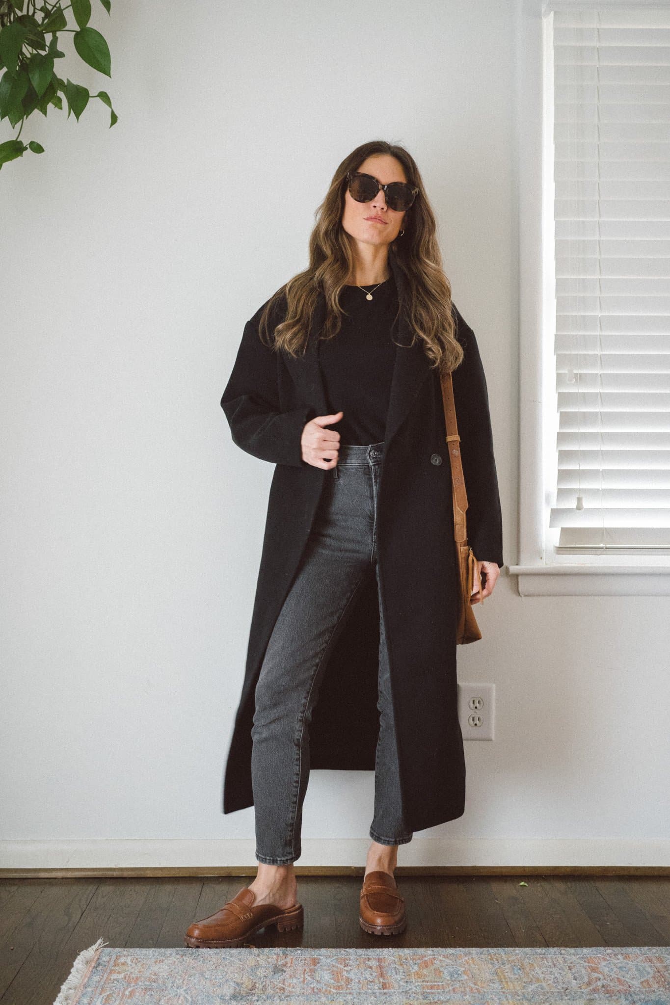 Long Black Wool Coat Over T-Shirt and Grey Jeans Long Black Wool Coat Over T-Shirt and Grey Jeans — Minimalist Winter Outfits