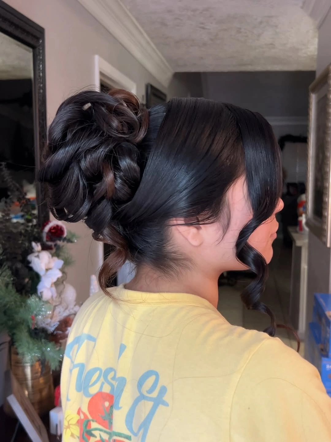Dark updo with smooth side sweep and curled face piece
