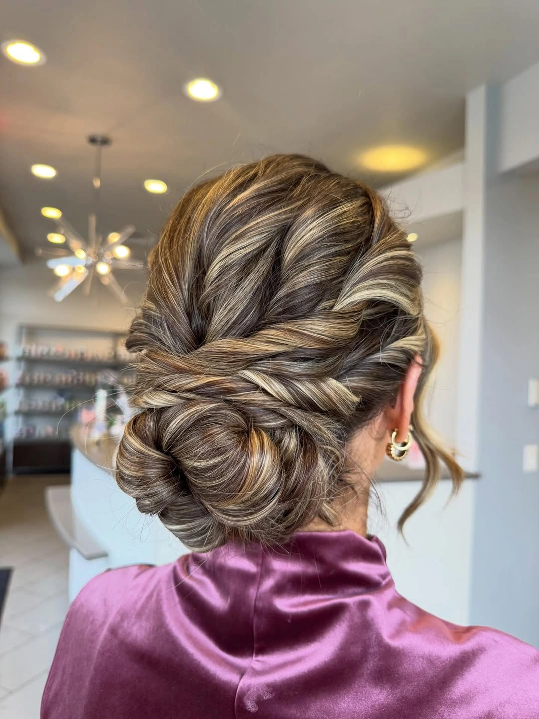 Low twisted updo with crossing light and dark strands