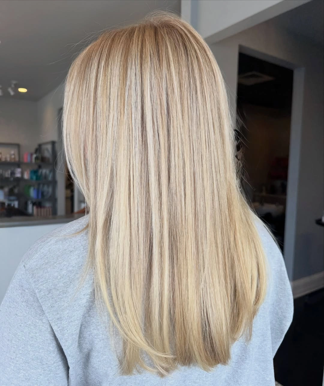 Straight blonde hair below shoulders with softly curved ends