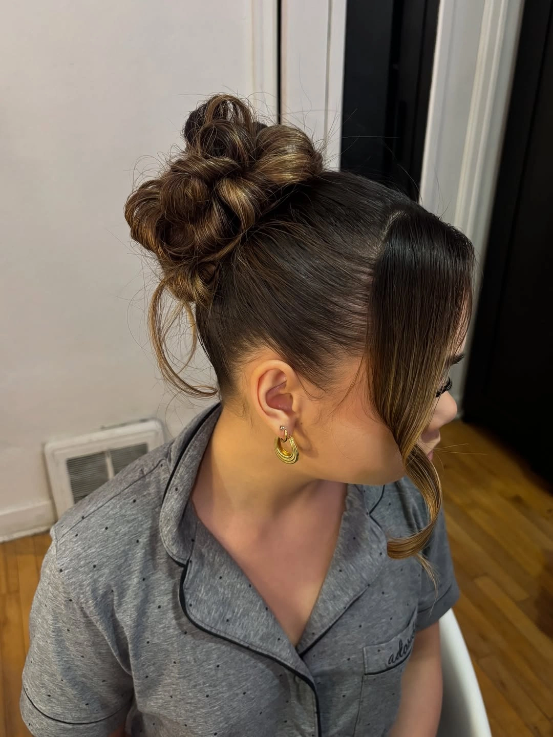 High bun with sleek sides and curled face-framing strands