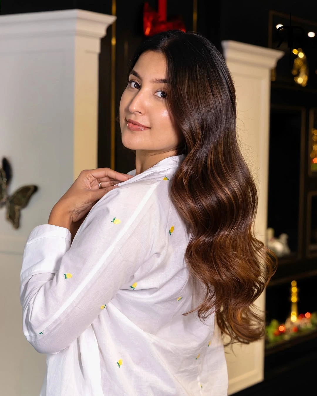 Long warm brunette hair with broad waves over shoulder