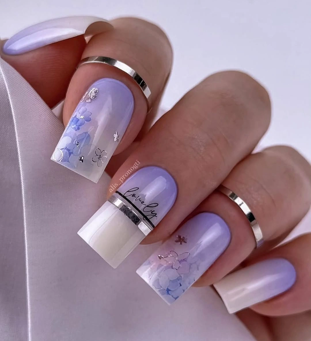 Long festive nails with character faces, stripes, stars, and studs