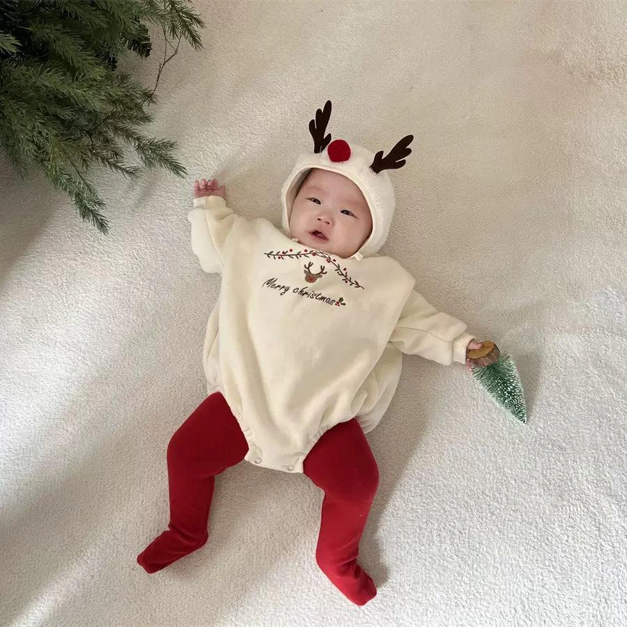 Baby in cream reindeer outfit with red footed tights