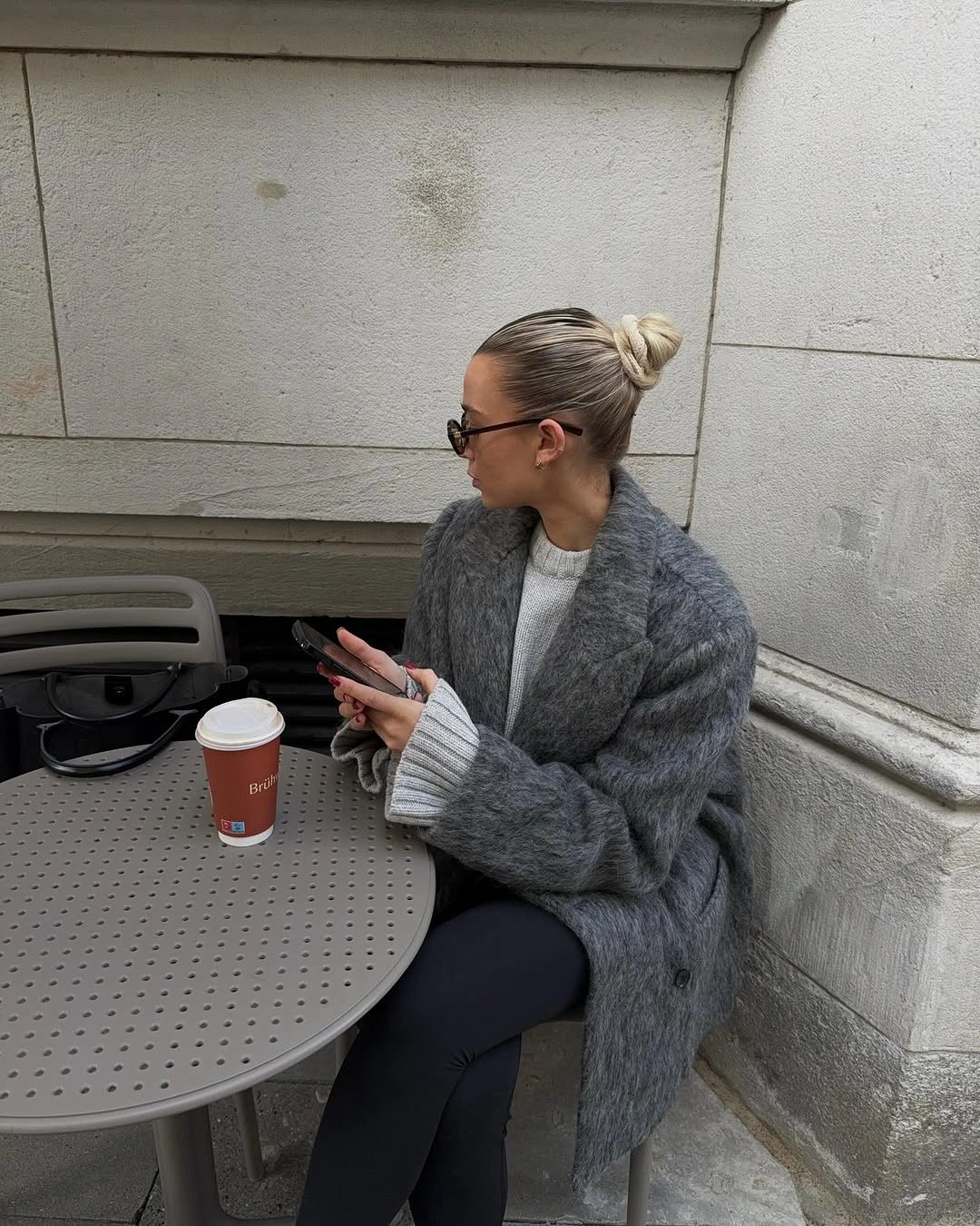 Gray fuzzy-looking cardigan with white top and black leggings