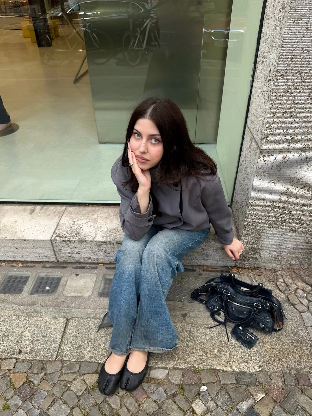 Gray jacket, dark top, wide jeans, black ballet flats