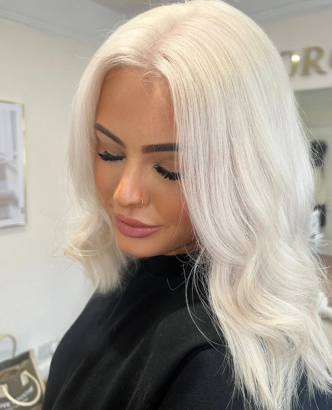 Very pale blonde shoulder-length hair with soft bends at the ends.