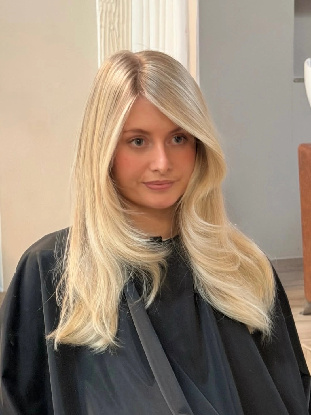 Warm blonde hair with brighter curved sections framing the front.