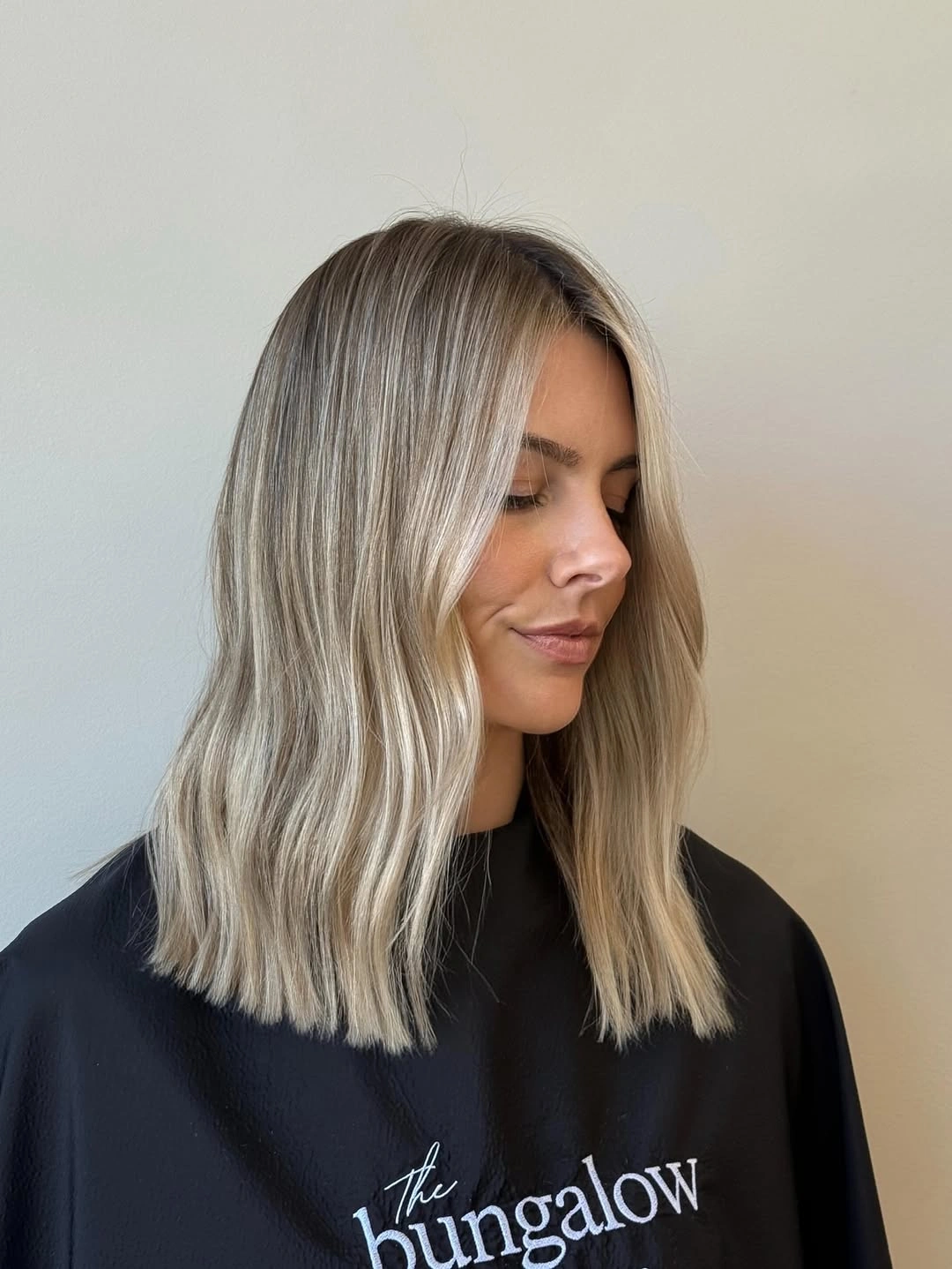 Shoulder-length cool beige-blonde hair with a darker upper area.