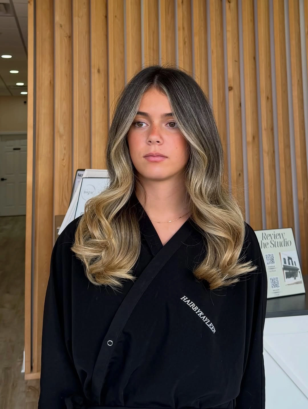 Dark brunette upper hair transitioning into curled beige-blonde lengths.