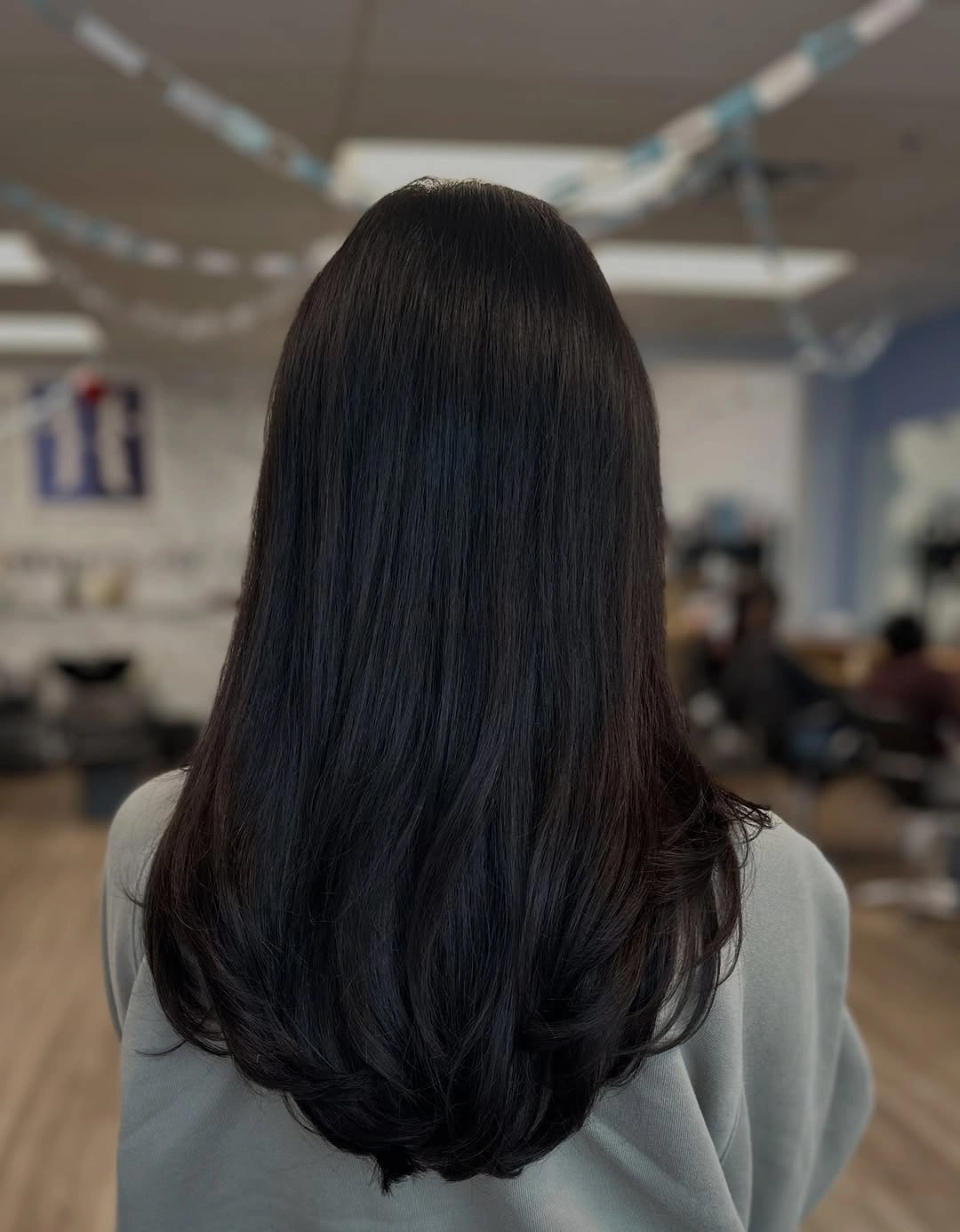Long dark hair viewed from behind with softly curved ends