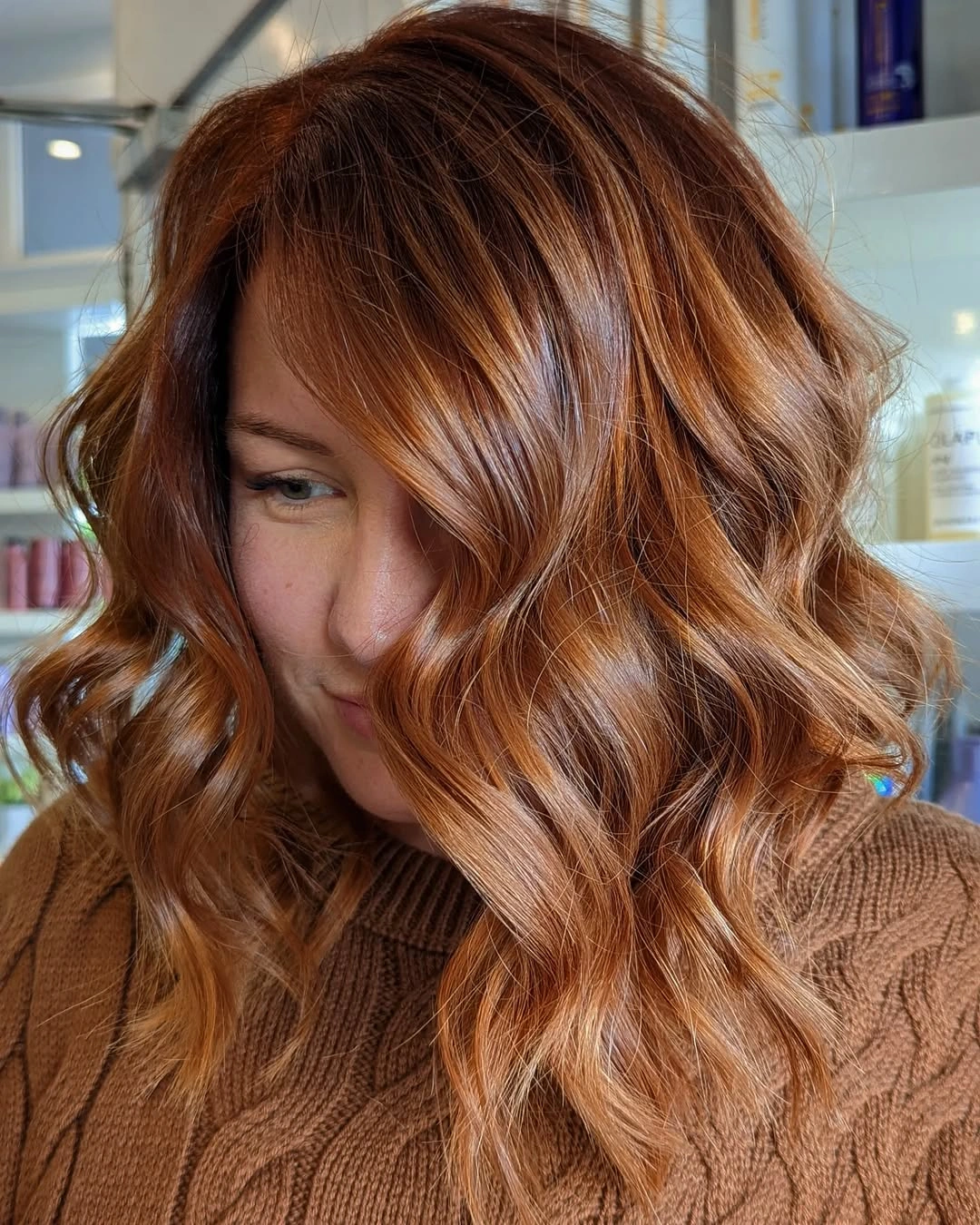 Medium-long copper-auburn hair with broad waves and soft movement
