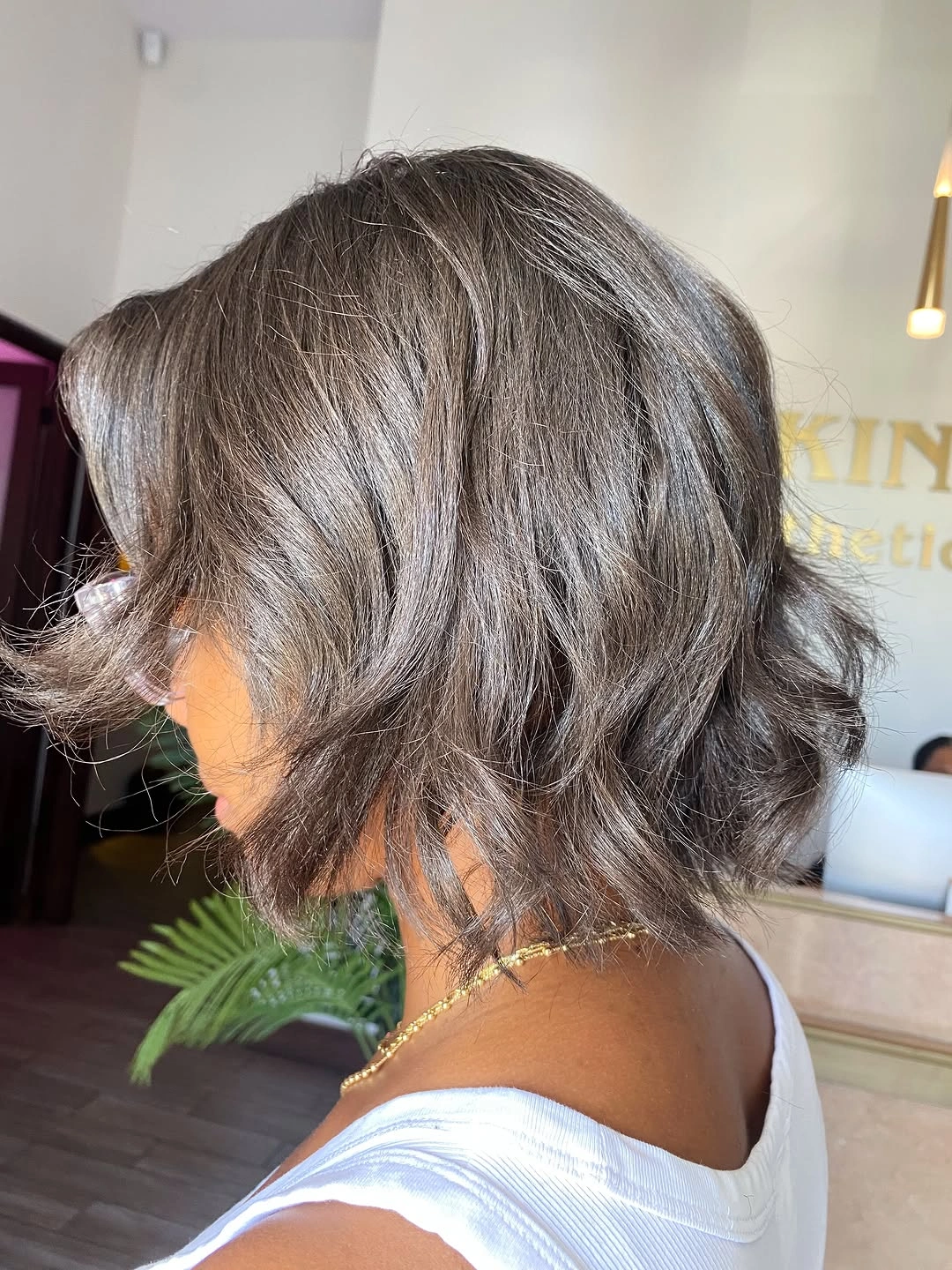 Short gray-looking wavy hair viewed from side and back