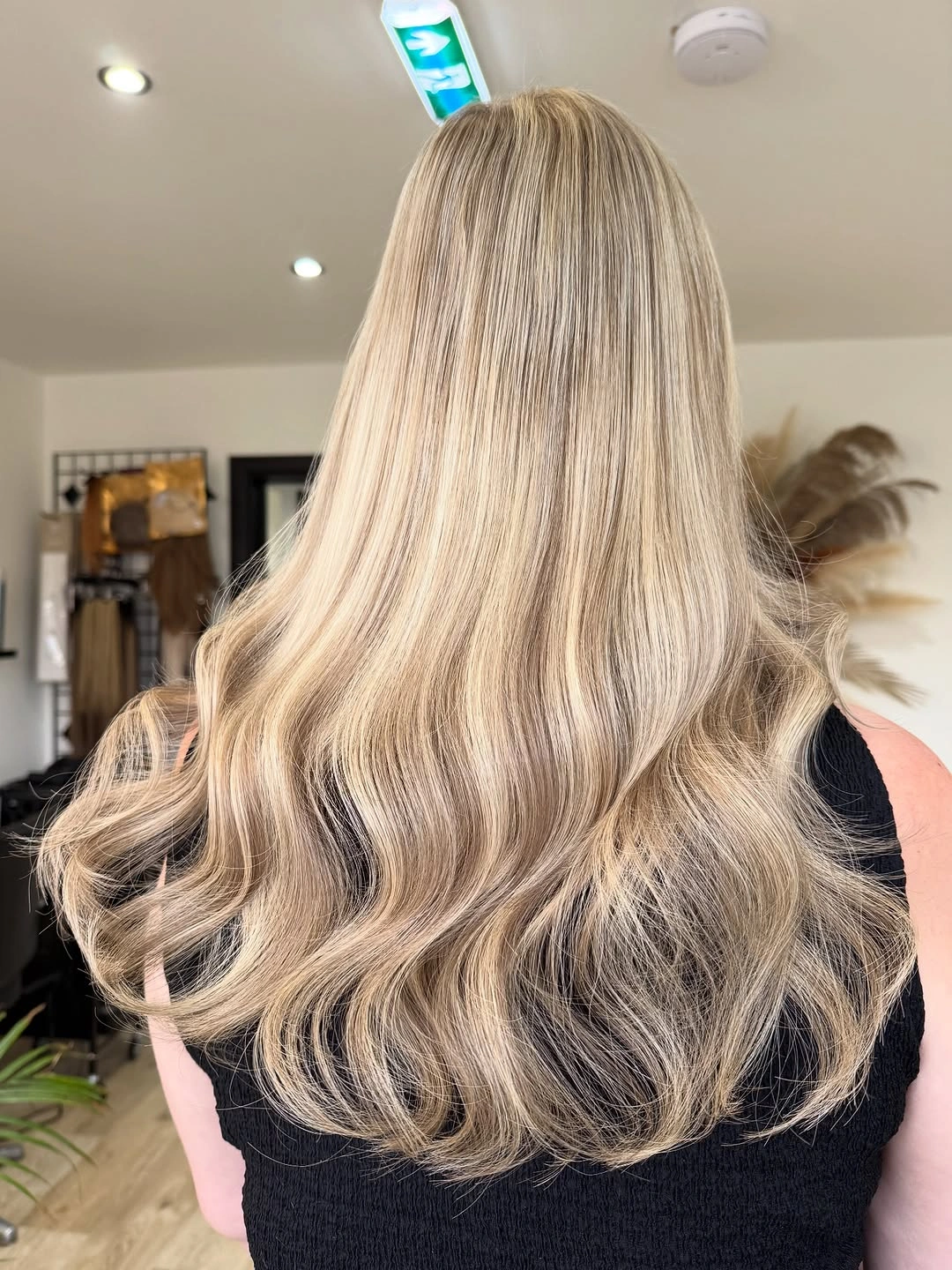 Very long pale blonde hair with lower waves viewed from behind