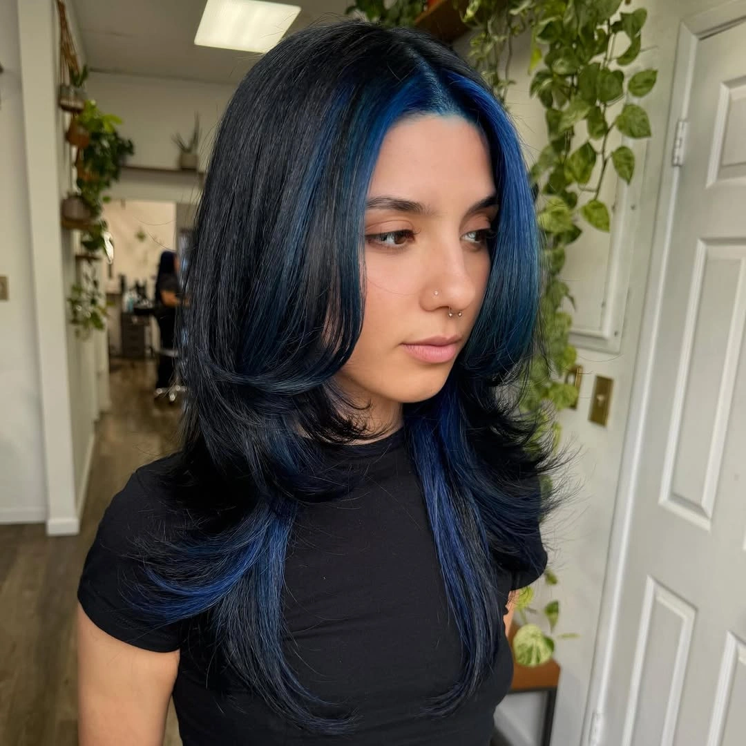 Dark shag-like hair with blue sections and separated longer pieces