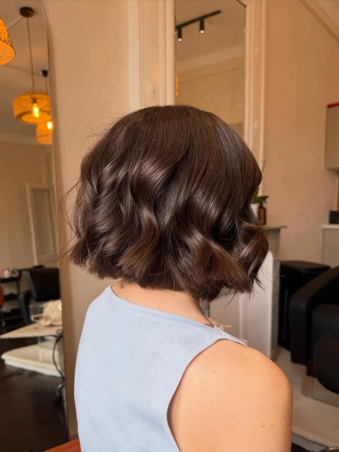 Short brunette wavy bob-like shape viewed from behind