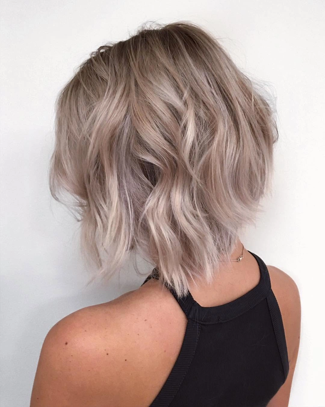 Short pale tousled hair with separated waves and broken-looking ends