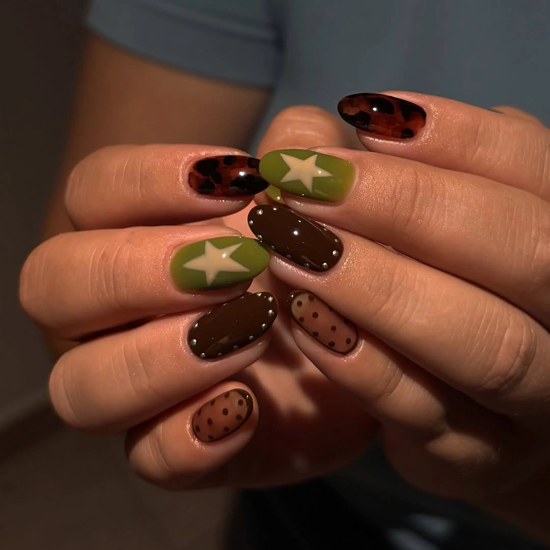 Short nails with olive stars, brown polish and dotted accents