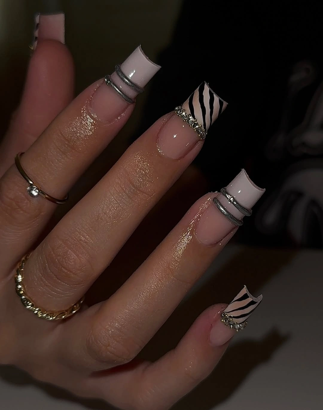 Long square nude nails with pale tips and black striping