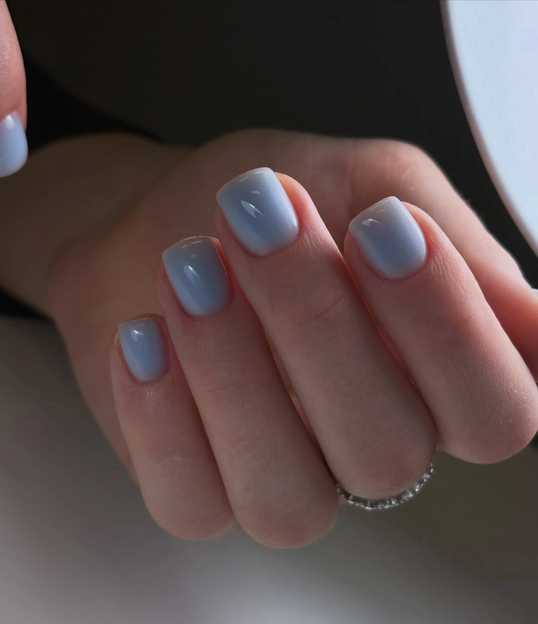 Short rounded nails with multicolor panels and bright metallic outlines