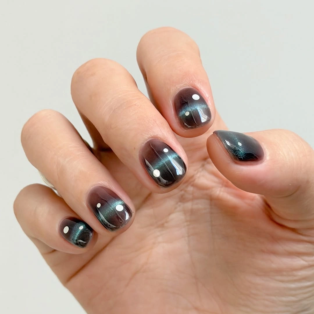 Long pointed nails with pink panels and raised-looking gold outlines