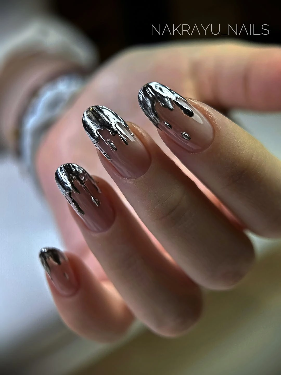 Almond nails with blush pink, gold studs, bands, and ridged surfaces