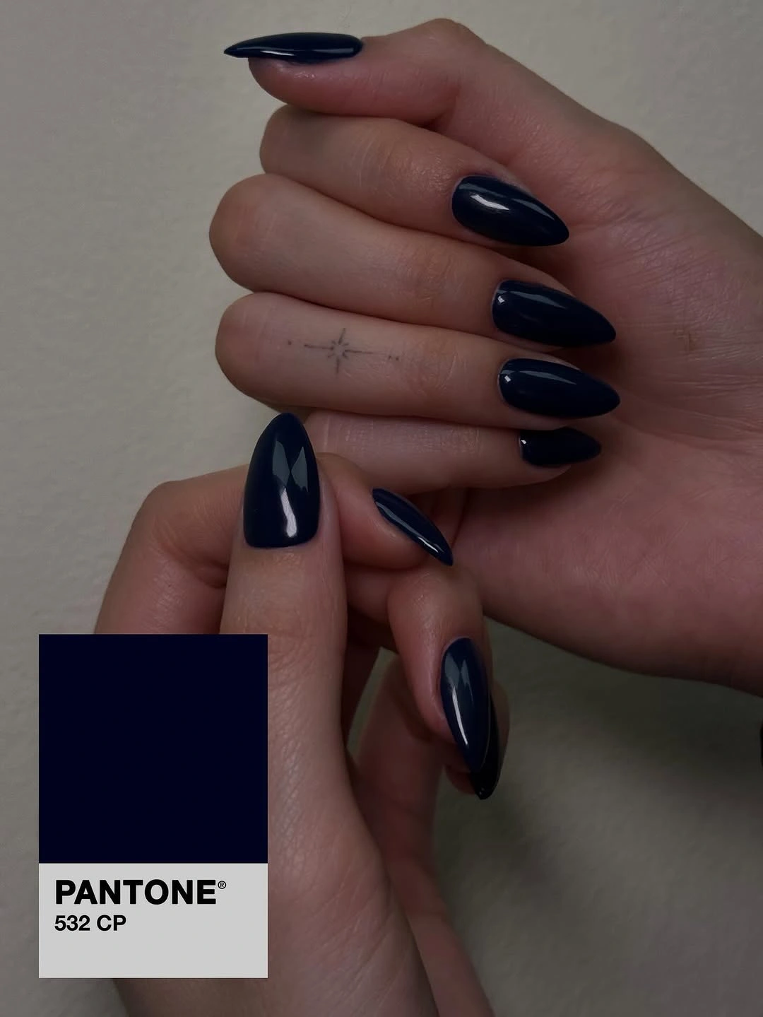 Long pointed nude nails with black hearts and contrasting tips
