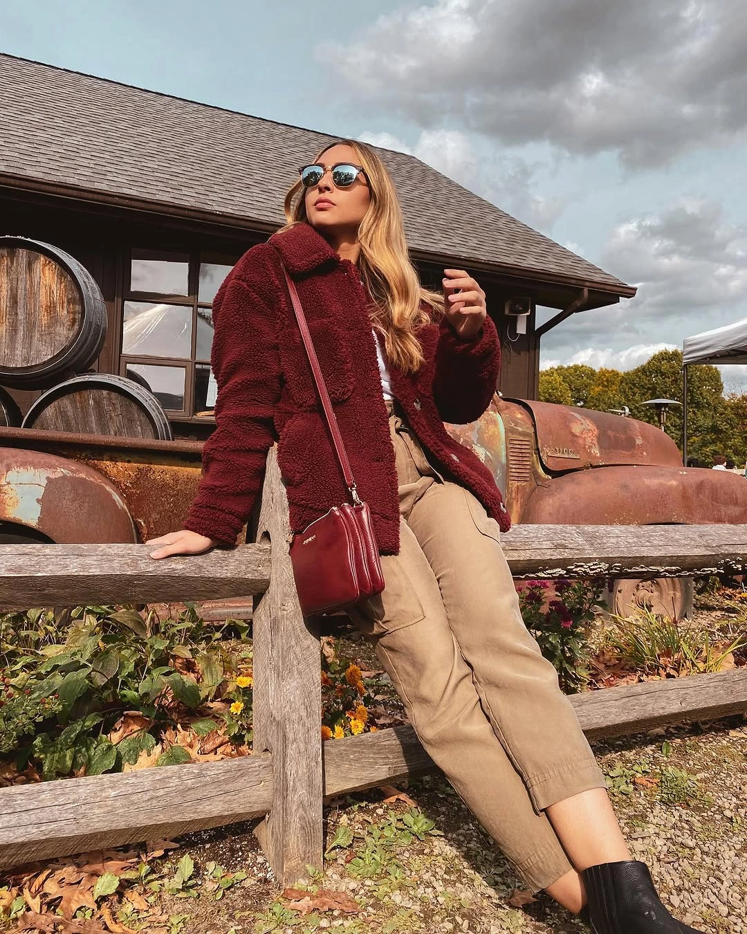 Burgundy textured jacket with beige cargo pants and black ankle boots