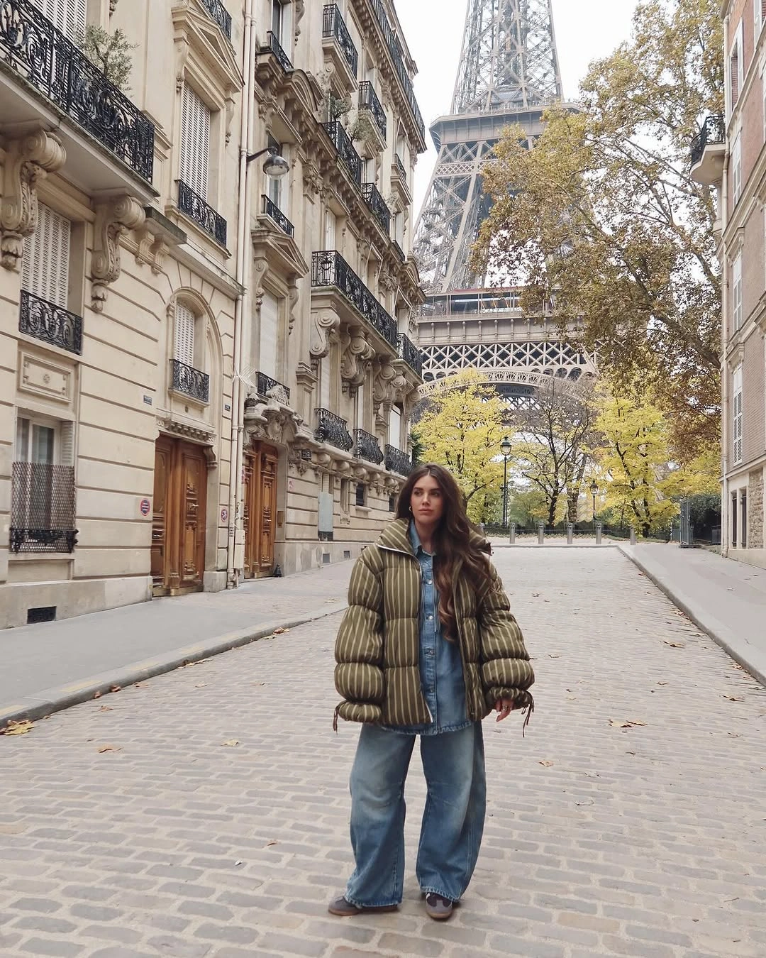Olive padded-looking jacket with denim layers on Paris street