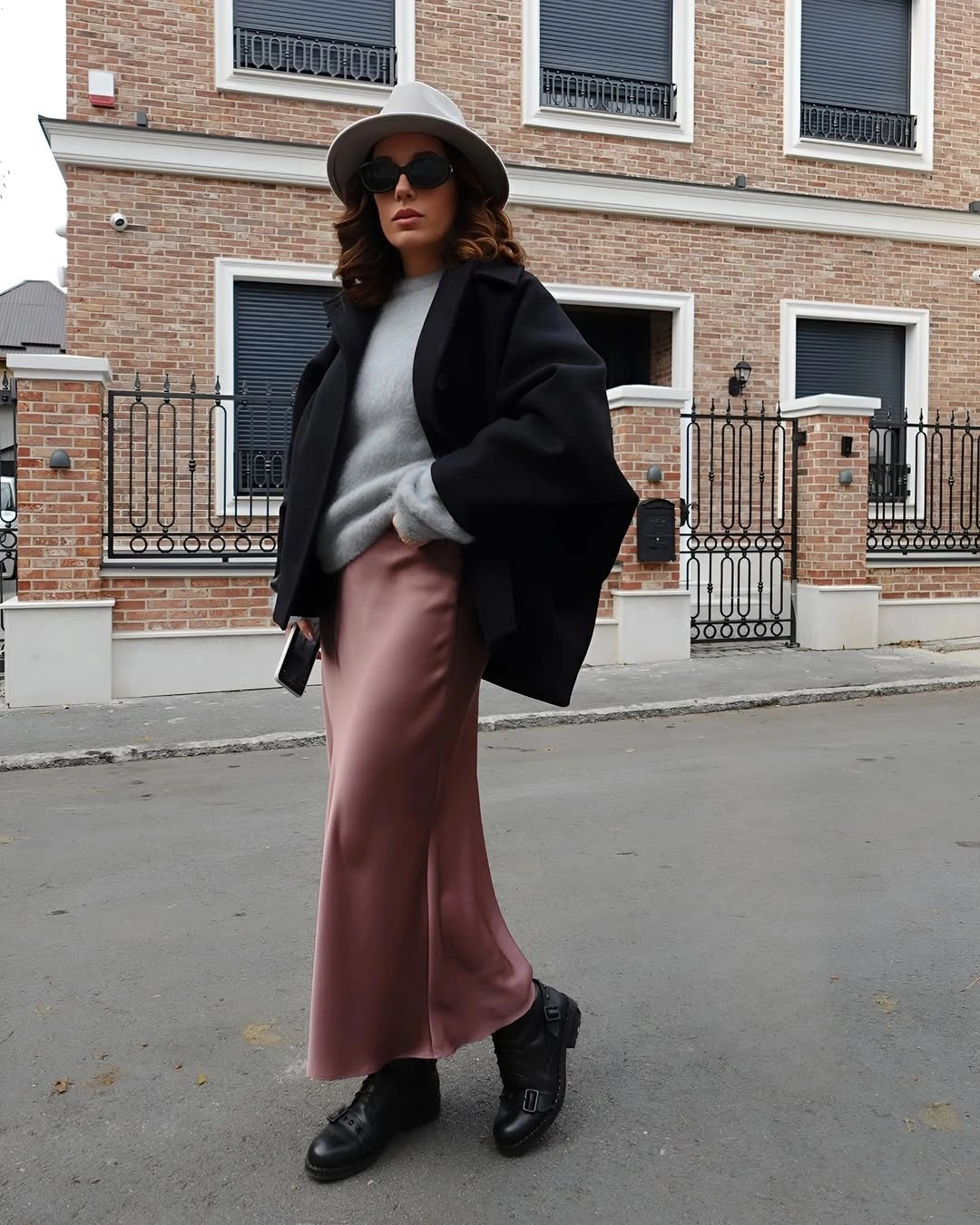 Black cape-like outer layer with gray hat and dusty pink skirt