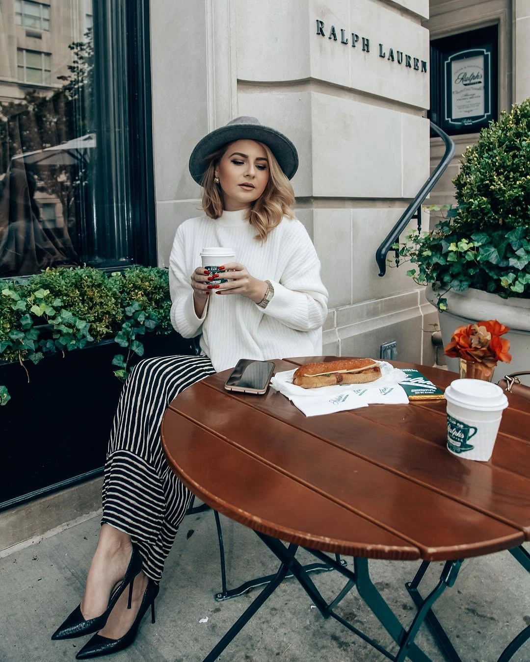 Off-white sweater with gray hat, striped lower layer and pointed heels