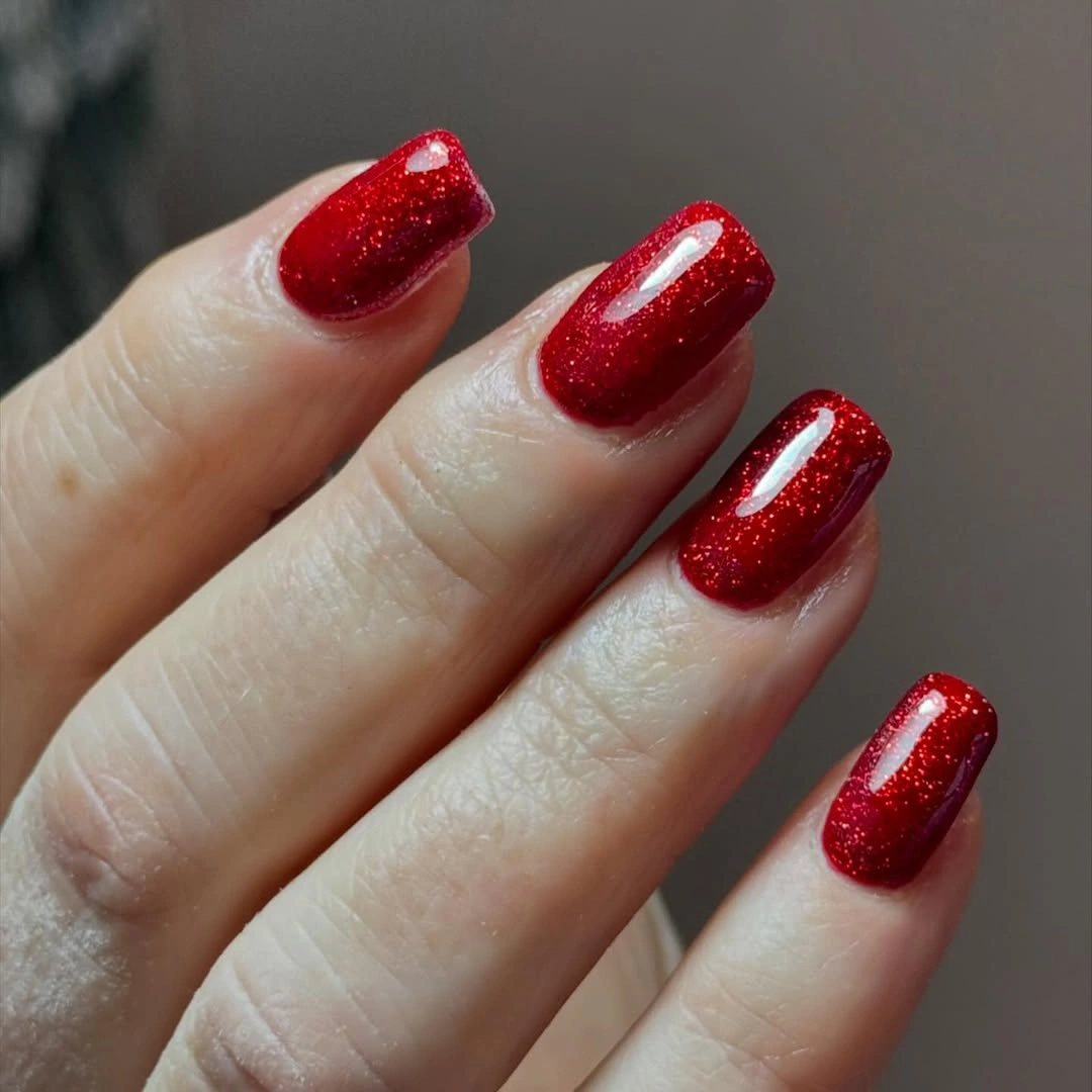Almond nails with red glitter tips and gold details