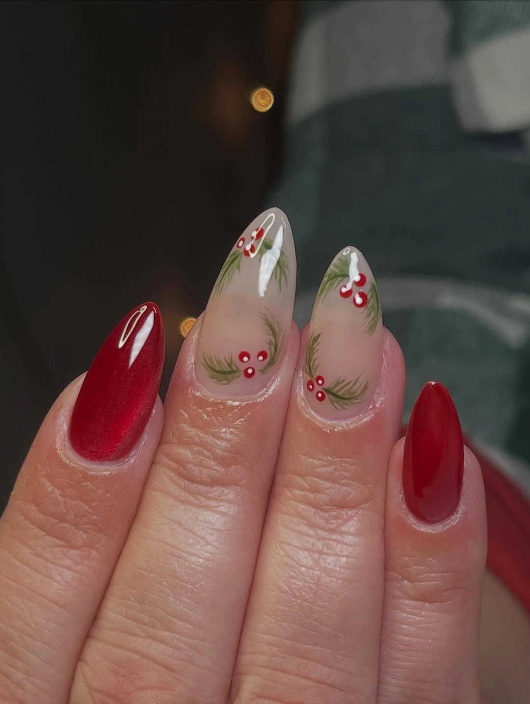 Short rounded-square nails with dark red reflective shimmer