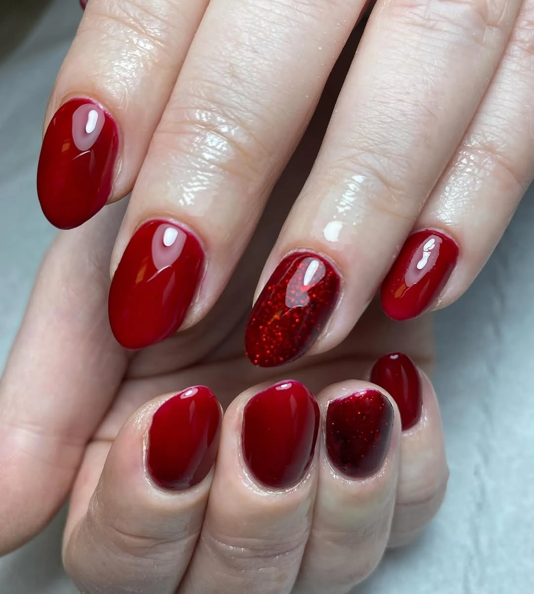 Short rounded red pink and white nails with black polka dots